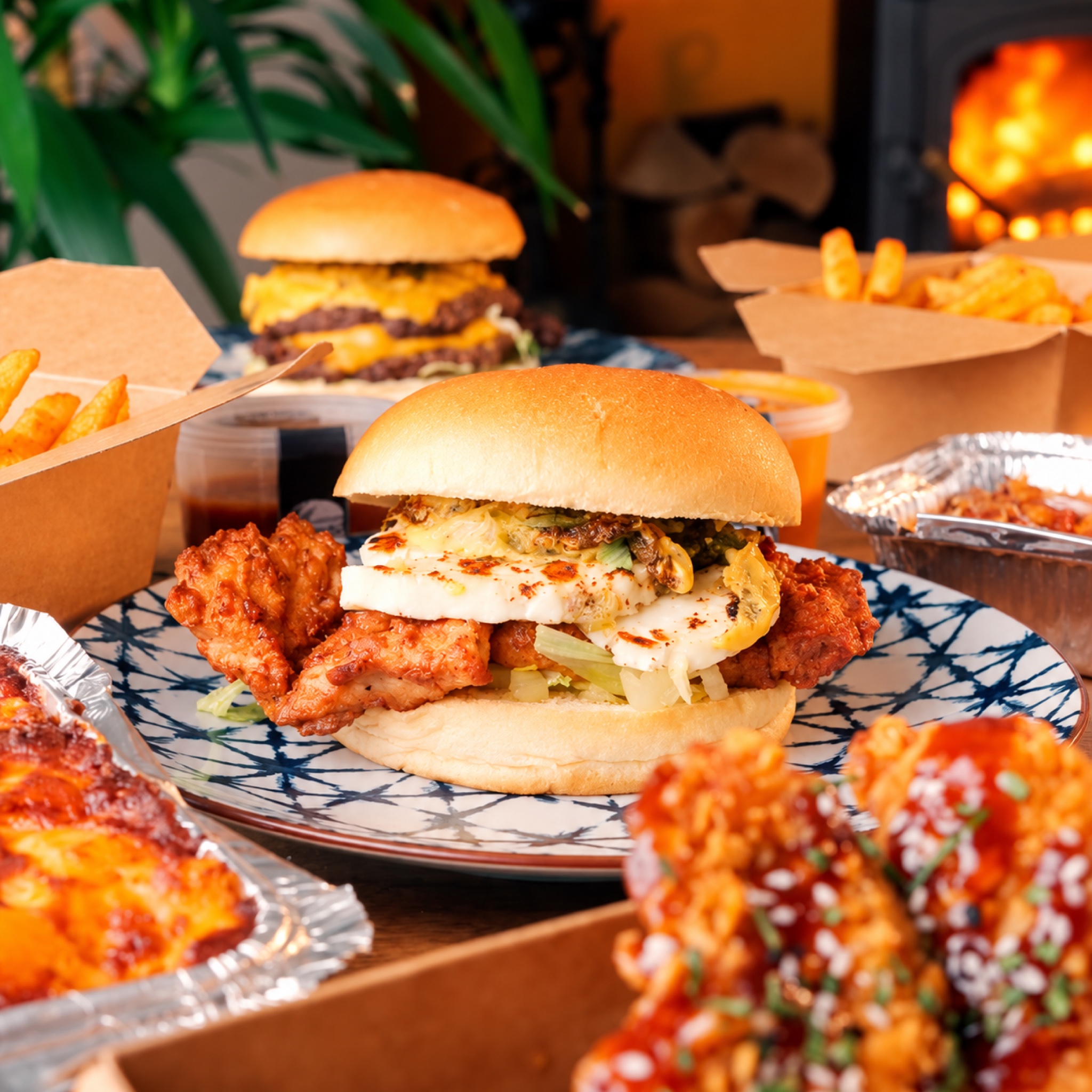 Burgers, fries and sides unpacked on the table at home