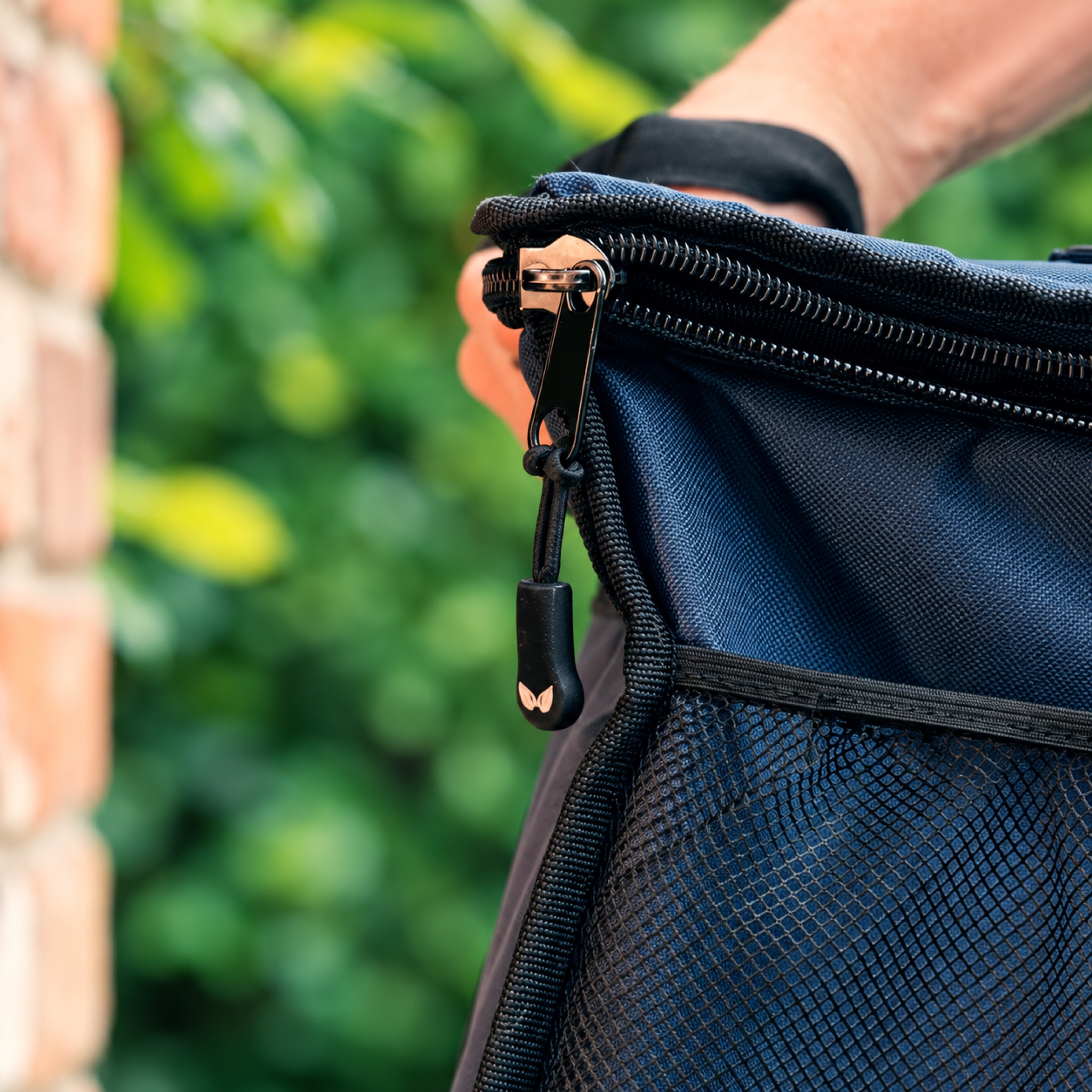 An insulated takeaway bag being carried outside