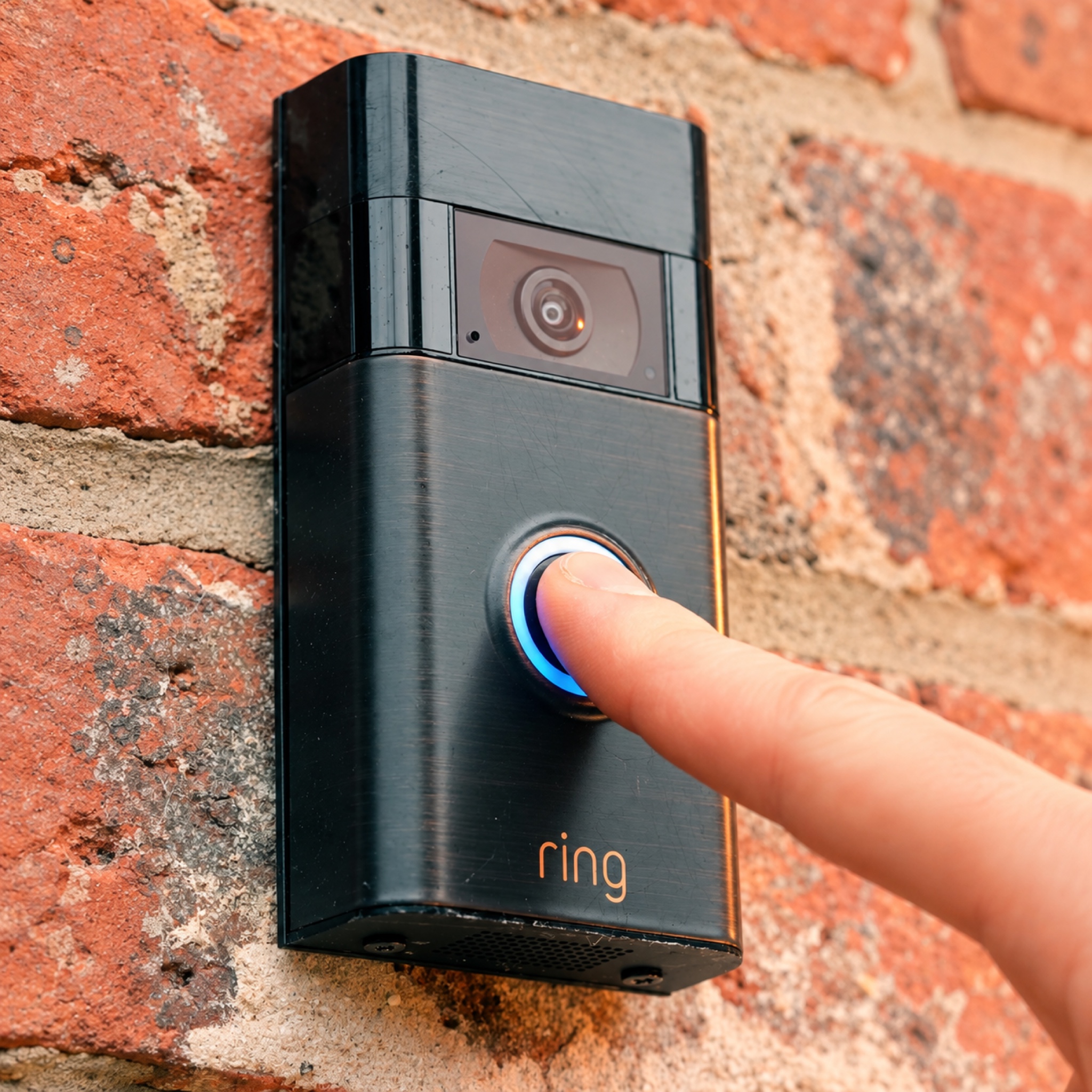 A finger pressing a doorbell