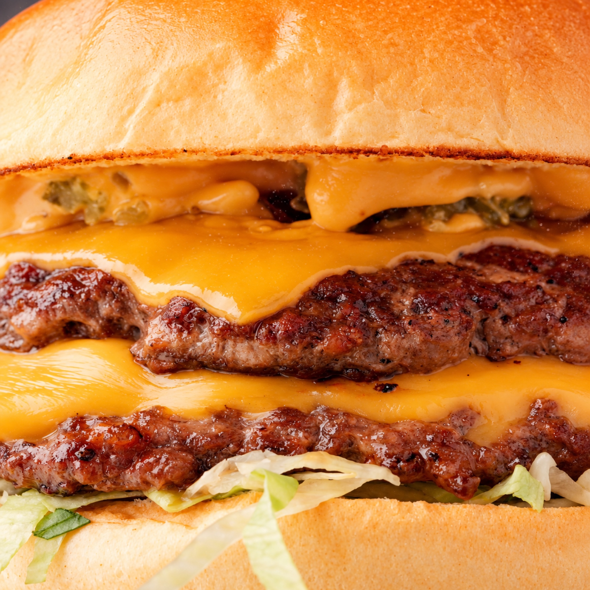 A double cheeseburger with melted cheese and pickles