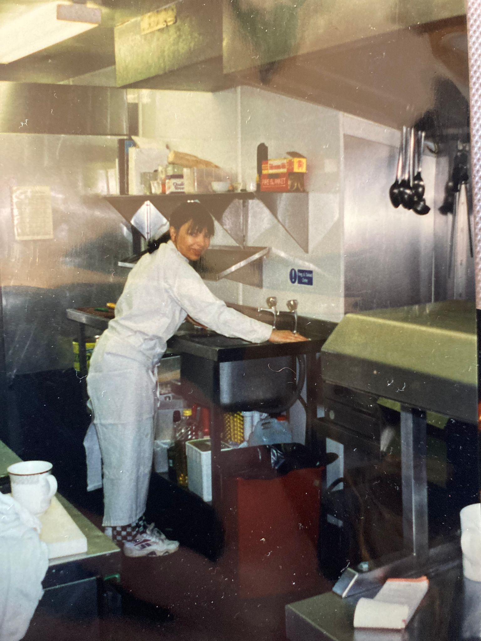 An archive photograph of a young person in chef whites in a kitchen